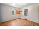 Simple bedroom with hardwood floors and a window at 2677 S Platte River Rd, Sedalia, CO 80135