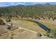 Aerial view of riverfront property with home and surrounding landscape at 2677 S Platte River Rd, Sedalia, CO 80135