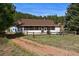 Charming house exterior with fenced yard and kayaks at 2677 S Platte River Rd, Sedalia, CO 80135