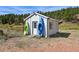 White storage shed with kayaks and mountain view at 2677 S Platte River Rd, Sedalia, CO 80135