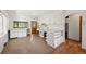 Retro kitchen with white cabinets and wood floors at 2677 S Platte River Rd, Sedalia, CO 80135