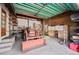 Garage with tractor, shelving, and workbench at 2677 S Platte River Rd, Sedalia, CO 80135