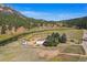 Aerial view of house and property near river and mountains at 2677 S Platte River Rd, Sedalia, CO 80135