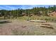 Large backyard with wooden deck, fire pit and horseshoe pit at 2677 S Platte River Rd, Sedalia, CO 80135