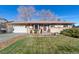 Ranch-style home with attached garage and landscaped yard at 12017 W New Mexico Ave, Lakewood, CO 80228