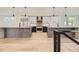 Modern kitchen boasts two islands, stainless steel appliances, and hardwood floors at 3212 S Dahlia St, Denver, CO 80222