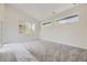 Spacious bedroom with gray carpet, multiple windows, and private deck access at 3212 S Dahlia St, Denver, CO 80222