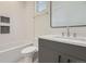 Modern bathroom with gray vanity, white subway tile, and bathtub at 3212 S Dahlia St, Denver, CO 80222