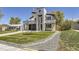Modern home with stone exterior, two-car garage, and landscaped yard at 3212 S Dahlia St, Denver, CO 80222