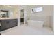 Spa-like bathroom with freestanding tub, modern vanity, and patterned tile at 3212 S Dahlia St, Denver, CO 80222
