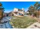 Large backyard with a deck, patio, and grassy area at 1324 Shadow Mountain Dr, Highlands Ranch, CO 80126
