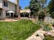 Landscaped backyard with pond and spacious lawn at 1324 Shadow Mountain Dr, Highlands Ranch, CO 80126