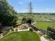 Landscaped backyard with a pond and spacious lawn at 1324 Shadow Mountain Dr, Highlands Ranch, CO 80126
