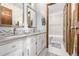 Clean bathroom with double sinks, a bathtub, and modern finishes at 1324 Shadow Mountain Dr, Highlands Ranch, CO 80126