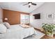 Spacious primary bedroom with high ceilings, large window and a TV at 1324 Shadow Mountain Dr, Highlands Ranch, CO 80126