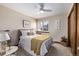 Bright bedroom with a queen-size bed, window, and ceiling fan at 1324 Shadow Mountain Dr, Highlands Ranch, CO 80126