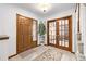 Bright entryway with wood floors, a coat closet, and French doors at 1324 Shadow Mountain Dr, Highlands Ranch, CO 80126