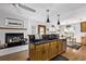 Kitchen with island, stainless steel appliances, and fireplace at 1324 Shadow Mountain Dr, Highlands Ranch, CO 80126