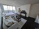 Living area with sliding glass doors to the balcony, a couch, a bed, and city views at 1020 15Th St # 21M, Denver, CO 80202