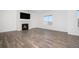 Living room with hardwood floors, fireplace, and large TV at 18235 Caffey Dr, Parker, CO 80134