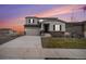 Two-story house with gray siding, attached garage, and landscaping at 18235 Caffey Dr, Parker, CO 80134