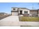 Two-story house with gray siding, attached garage, and landscaping at 18235 Caffey Dr, Parker, CO 80134