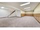 Finished basement with ample space and stairs at 1627 E Jamison Pl, Centennial, CO 80122