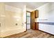 Clean bathroom with bathtub and wood cabinets at 1627 E Jamison Pl, Centennial, CO 80122