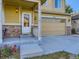 House entrance with covered porch, stone accents, and a double garage at 1512 Lasalle Way, Longmont, CO 80504