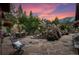 Evening view of a stone patio with waterfall and mountain views at 1420 Sierra Dr, Boulder, CO 80302