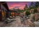 Expansive stone patio with seating and a tranquil waterfall feature at 1420 Sierra Dr, Boulder, CO 80302