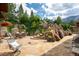 Landscaped patio with flagstone, waterfall feature, and seating area at 1420 Sierra Dr, Boulder, CO 80302