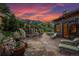 Stone patio with seating, string lights, and mountain views at sunset at 1420 Sierra Dr, Boulder, CO 80302