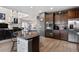 Kitchen with island, stainless steel appliances, and dark wood cabinets at 463 N Jamestown Way, Aurora, CO 80018