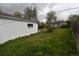 Side yard view of the property with detached shop and grassy area at 1881 S Saint Paul St, Denver, CO 80210