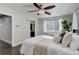 Bright bedroom with a large bed, window seat, and en-suite bathroom at 2311 Decatur St, Denver, CO 80211