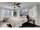 Bright bedroom with ceiling fan, large window, and hardwood floors at 2311 Decatur St, Denver, CO 80211
