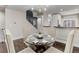 Modern dining area with glass top table and four chairs at 2311 Decatur St, Denver, CO 80211