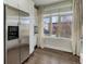 Modern kitchen with stainless steel appliances and dark hardwood floors at 2311 Decatur St, Denver, CO 80211