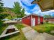 Rustic red cabin with a picnic table and wooden walkway in the backyard at 2752 Miner St, Idaho Springs, CO 80452