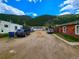 Gravel parking lot with several vehicles and surrounding buildings at 2752 Miner St, Idaho Springs, CO 80452