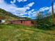 Long brown building with several windows and grassy area at 2752 Miner St, Idaho Springs, CO 80452
