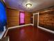 Bedroom with wood walls and red hardwood floors at 2752 Miner St, Idaho Springs, CO 80452