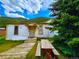 White house with yellow door and picnic table in front at 2752 Miner St, Idaho Springs, CO 80452