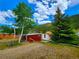 Red cabin with white trim next to a white house at 2752 Miner St, Idaho Springs, CO 80452