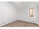 Simple bedroom with window, carpet, and neutral walls at 367 S Jasmine St, Denver, CO 80224