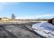 Open side yard with partial snow cover, spacious and versatile at 6316 Tennyson St, Arvada, CO 80003