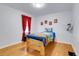 Charming bedroom with wood floors and red curtains at 6316 Tennyson St, Arvada, CO 80003