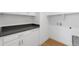 Bright laundry room with white cabinets and dark countertop at 14289 W Currant St, Broomfield, CO 80020