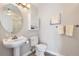 Small bathroom with pedestal sink and toilet at 2700 E Cherry Creek South Dr # 313, Denver, CO 80209